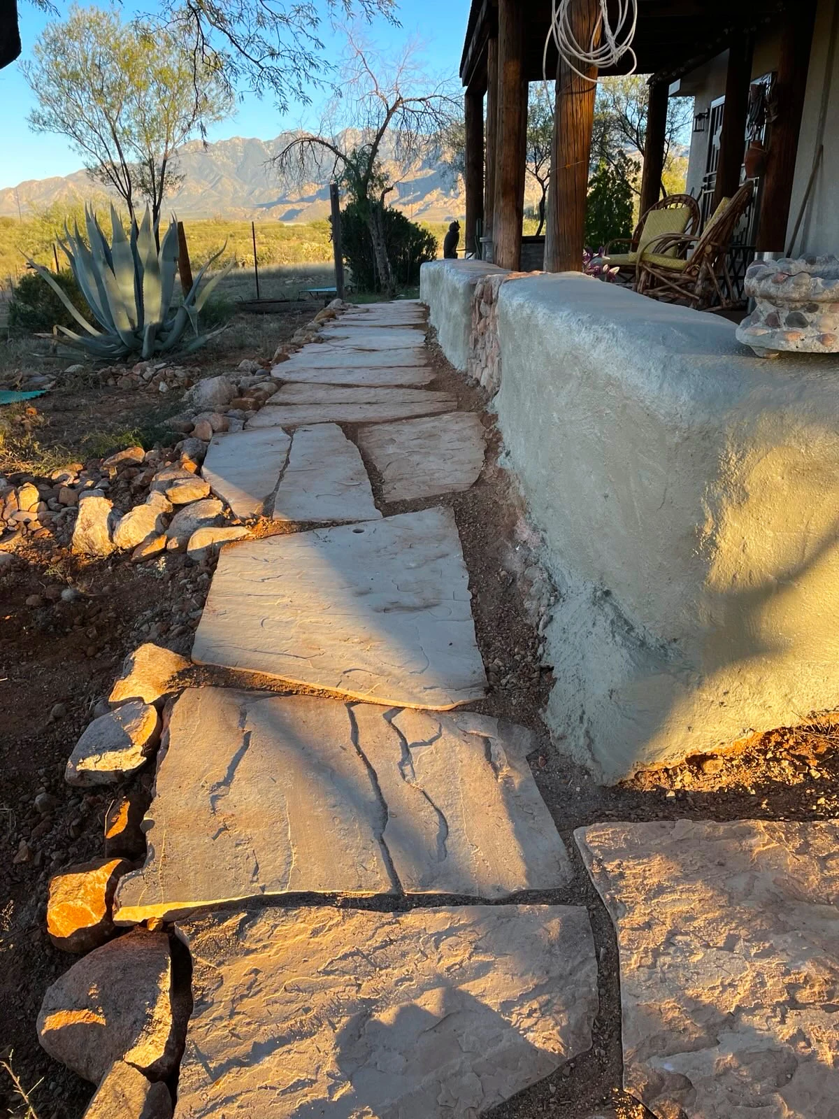Front porch design. Many large rock tiles surrounding the perimeter of the house